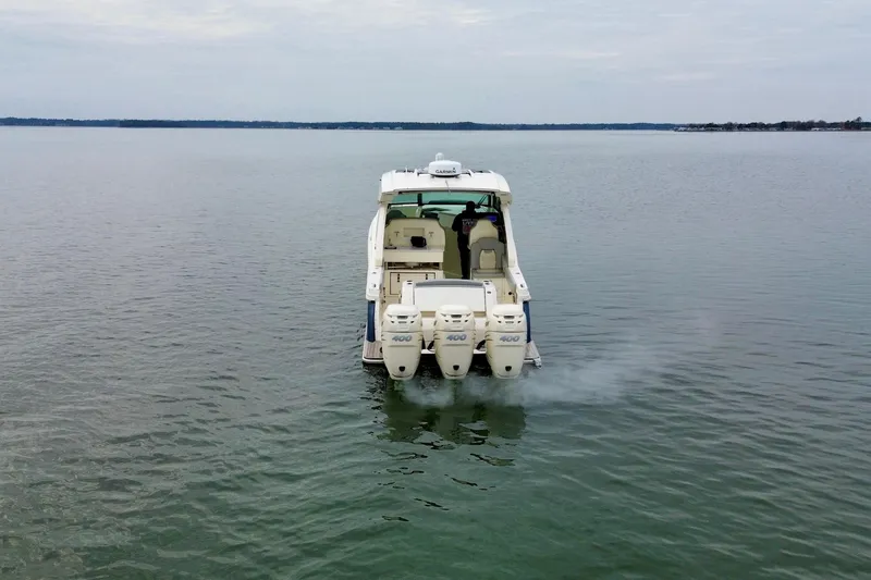 Slide: The Image of 2023 Scout 350 LXZ boat with triple engines on calm water. - 13