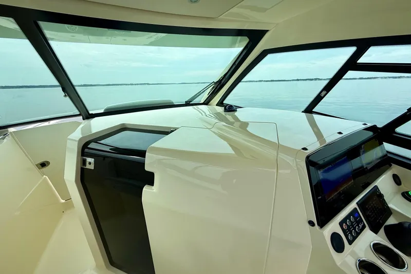 Slide: The Image of Interior view of 2023 Scout 350 LXZ boat cockpit with navigation controls. - 20