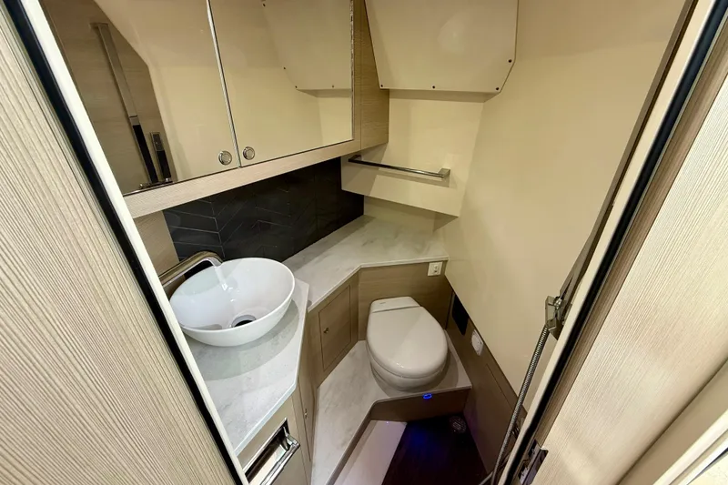Slide: The Image of 2023 Scout 350 LXZ boat bathroom with modern sink and toilet. - 24
