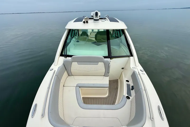 Slide: The Image of 2023 Scout 350 LXZ boat with spacious seating on calm water. - 28