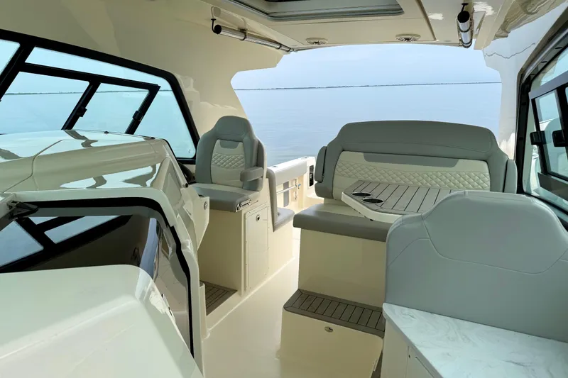 Slide: The Image of Luxurious interior of 2023 Scout 350 LXZ boat with elegant seating and panoramic windows. - 32