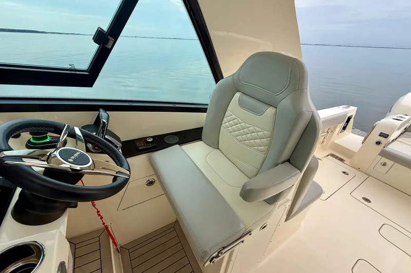 Slide: The Image of 2023 Scout 350 LXZ boat interior with steering wheel and luxurious seating. - 35