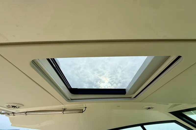 Slide: The Image of 2023 Scout 350 LXZ boat interior with open sunroof, showcasing sky view. - 36