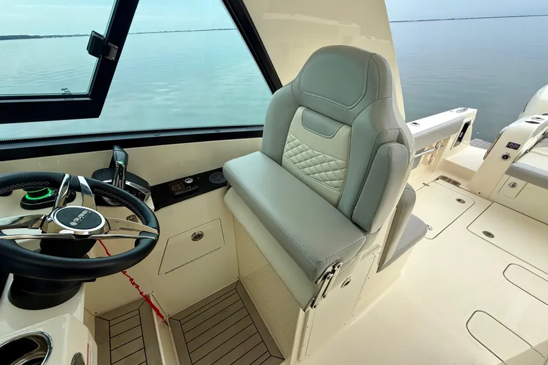 Slide: The Image of 2023 Scout 350 LXZ boat interior with steering wheel and luxurious seating. - 37