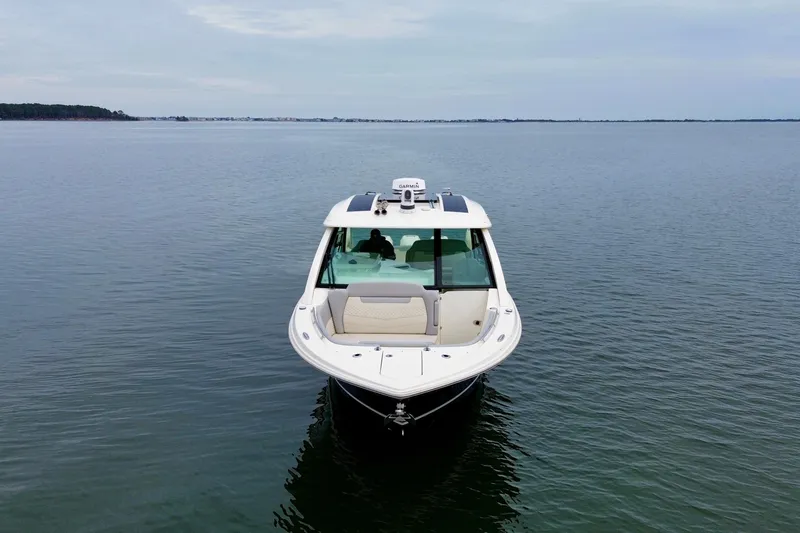 Slide: The Image of 2023 Scout 350 LXZ boat on calm water, front view. - 4