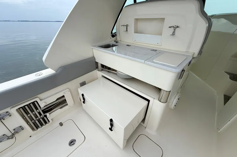 Slide: The Image of 2023 Scout 350 LXZ boat interior with sink and storage compartments. - 41