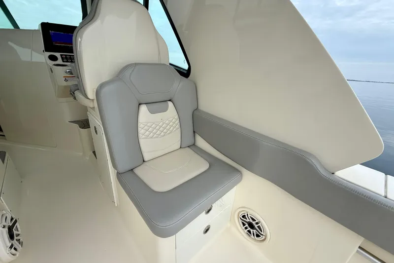 Slide: The Image of 2023 Scout 350 LXZ boat interior with gray and white seating. - 42