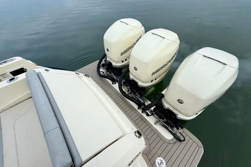 Slide: The Image of 2023 Scout 350 LXZ boat with triple Mercury outboard engines on calm water. - 47