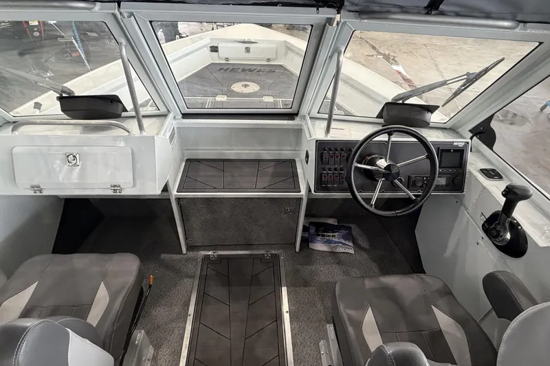 Slide: The Image of Interior view of 2026 Hewescraft 221 Evolution boat cockpit with steering wheel and seating. - 10