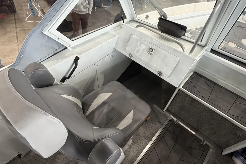 Slide: The Image of Interior of 2026 Hewescraft 221 Evolution boat with gray seating and dashboard. - 11