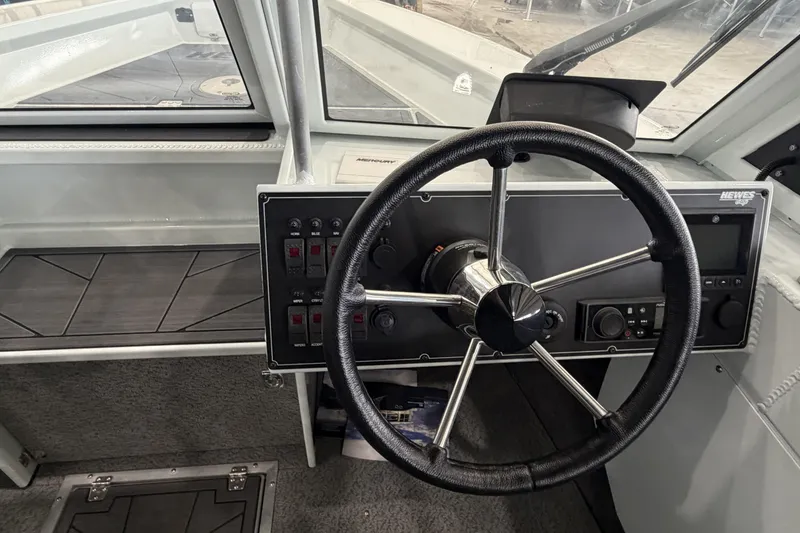 Slide: The Image of Steering wheel and dashboard of 2026 Hewescraft 221 Evolution boat. - 13