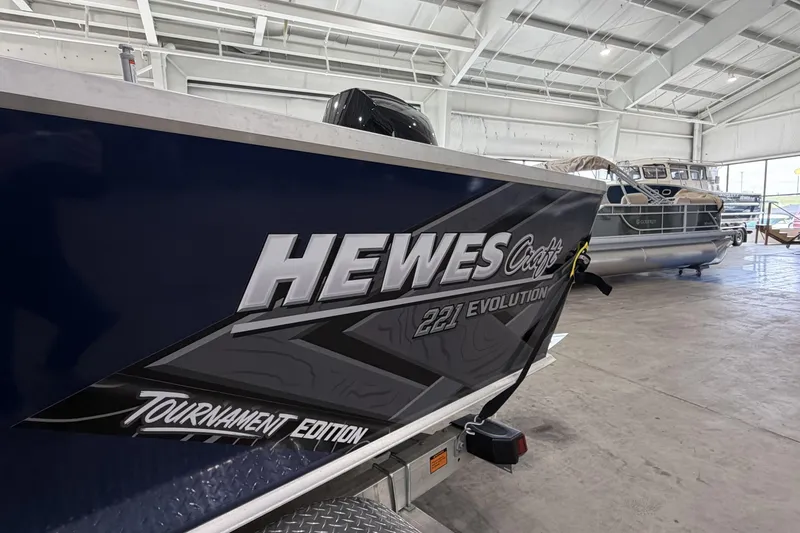 Slide: The Image of 2026 Hewescraft 221 Evolution boat in showroom, Tournament Edition model. - 20