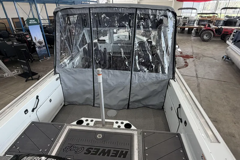 Slide: The Image of 2026 Hewescraft 221 Evolution boat interior with protective cover in showroom. - 4