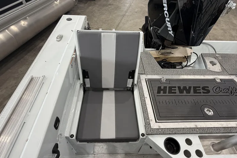 Slide: The Image of 2026 Hewescraft 221 Evolution boat interior with seating and Mercury engine. - 6
