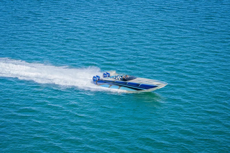 Slide: The Image of 2026 Nor-Tech 4000 Super Catamaran speeding on blue ocean waters. - 100