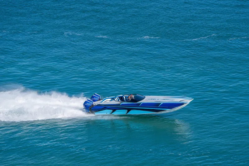 Slide: The Image of 2026 Nor-Tech 4000 Super Catamaran speeding on open water, showcasing sleek design. - 103