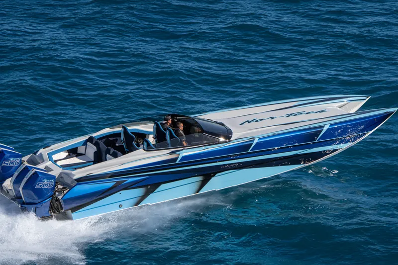 Slide: The Image of 2026 Nor-Tech 4000 Super Catamaran cruising on blue ocean waters. - 104