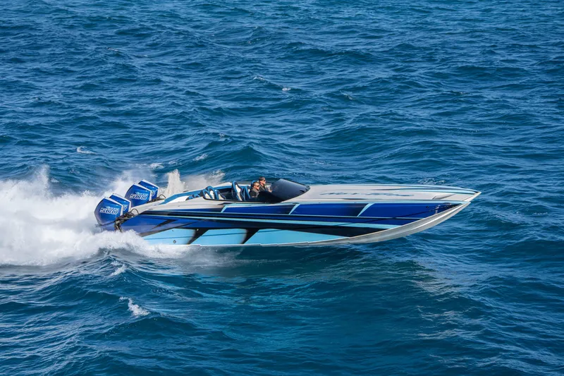 Slide: The Image of 2026 Nor-Tech 4000 Super Catamaran speeding on open blue ocean waters. - 105