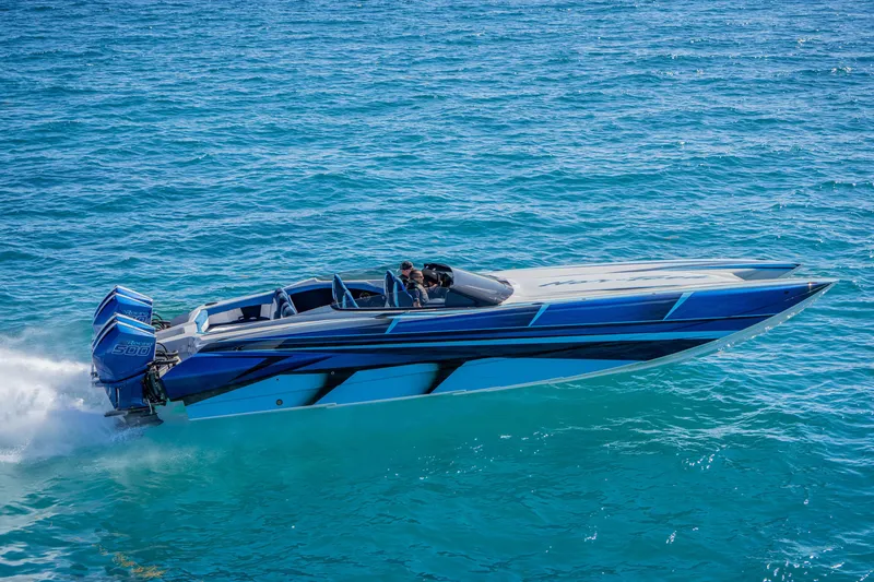 Slide: The Image of 2026 Nor-Tech 4000 Super Catamaran speeding on clear blue ocean waters. - 110