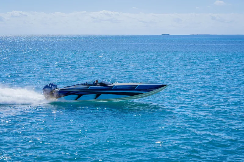 Slide: The Image of 2026 Nor-Tech 4000 Super Catamaran speeding on open blue ocean waters. - 112