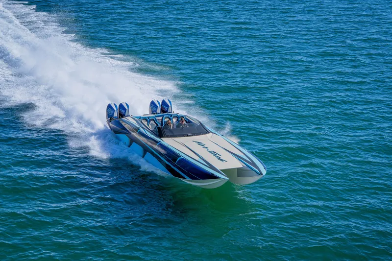 Slide: The Image of 2026 Nor-Tech 4000 Super Catamaran speeding on open water, showcasing sleek design and power. - 113
