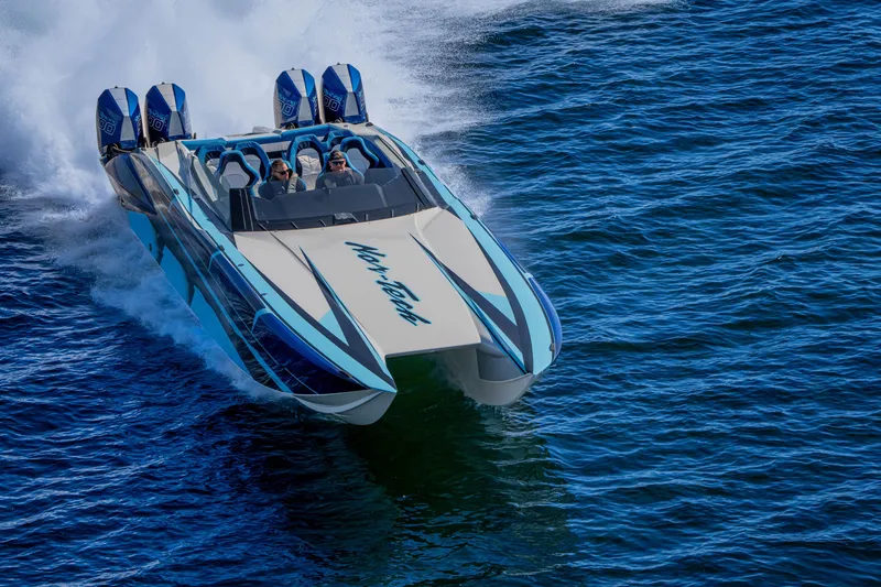 Slide: The Image of 2026 Nor-Tech 4000 Super Catamaran speeding on open water, showcasing sleek design and powerful engines. - 116