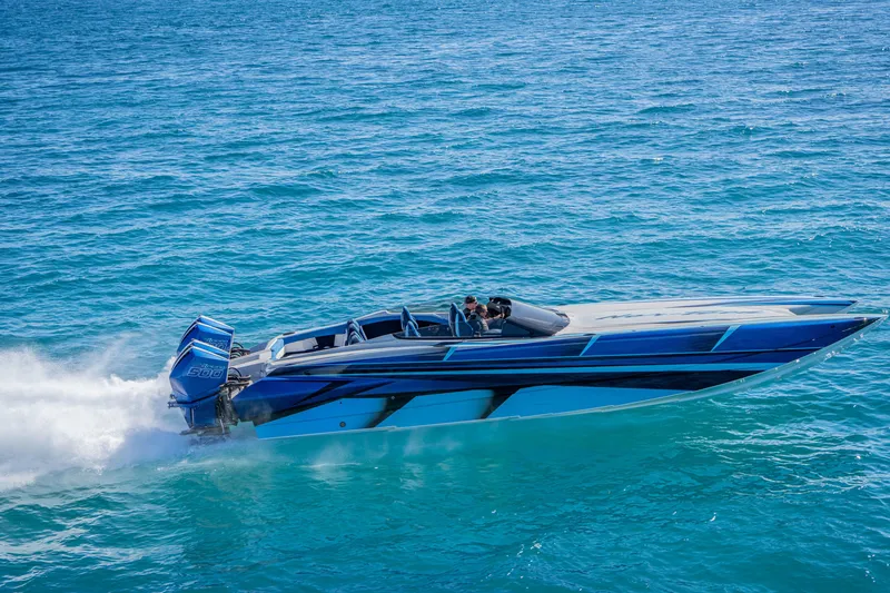 Slide: The Image of 2026 Nor-Tech 4000 Super Catamaran speeding on clear blue ocean waters. - 12