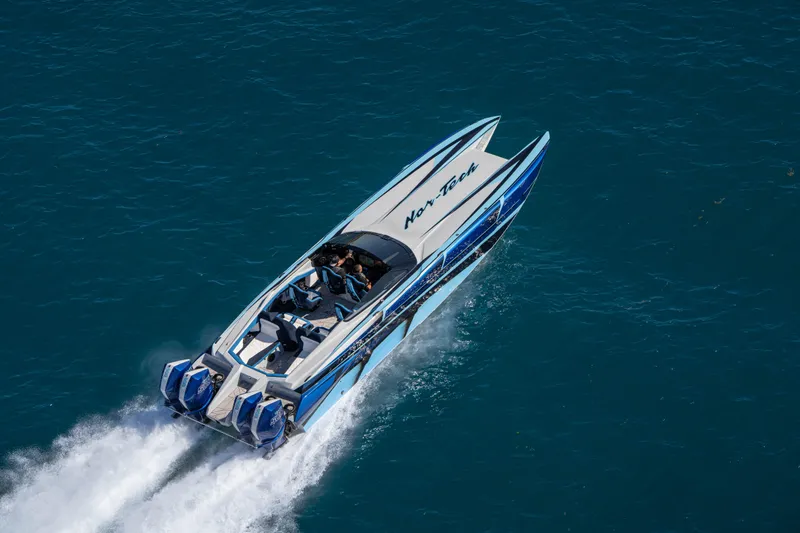 Slide: The Image of 2026 Nor-Tech 4000 Super Catamaran speeding on open water, showcasing sleek design. - 123