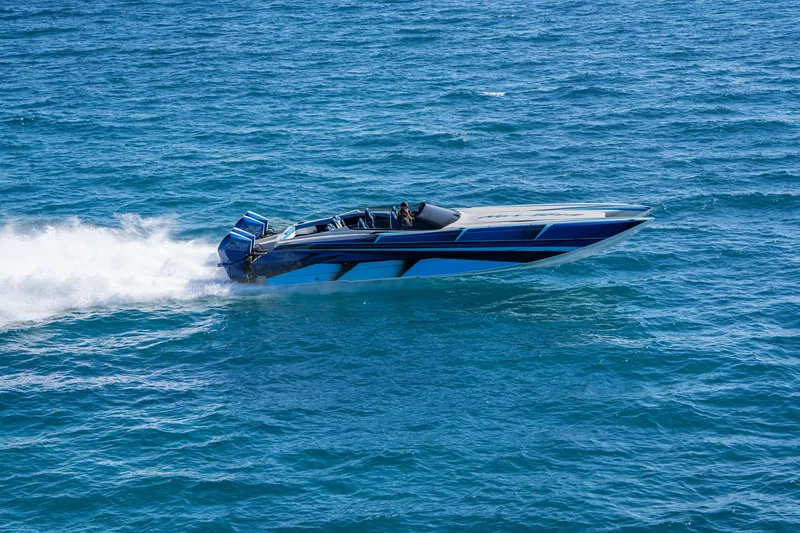 Slide: The Image of 2026 Nor-Tech 4000 Super Catamaran speeding on open water, showcasing sleek design. - 144