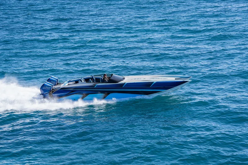 Slide: The Image of 2026 Nor-Tech 4000 Super Catamaran speeding on open water, showcasing sleek design. - 145