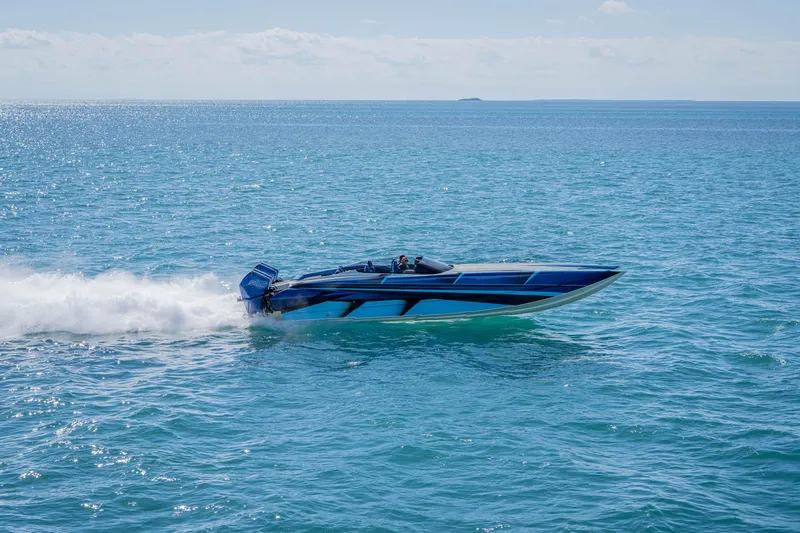Slide: The Image of 2026 Nor-Tech 4000 Super Catamaran speeding on open blue ocean waters. - 148