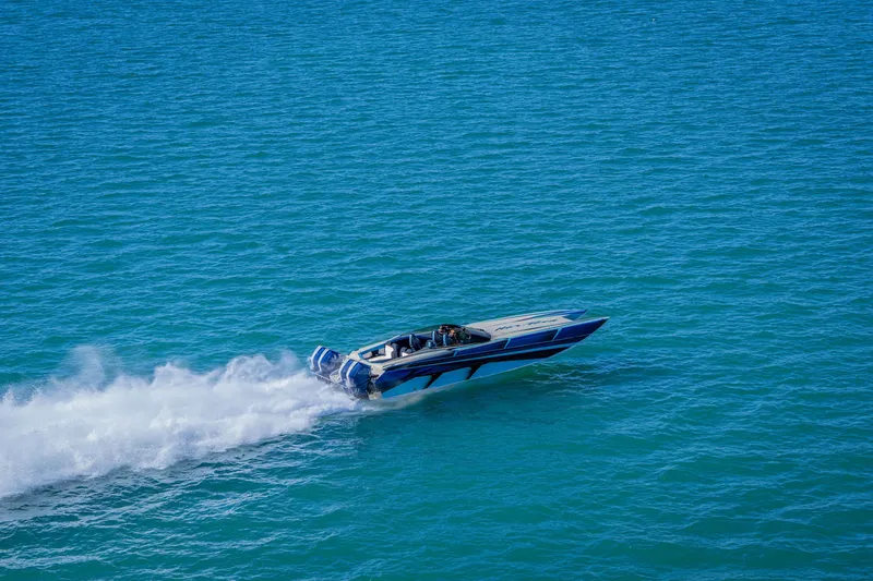 Slide: The Image of 2026 Nor-Tech 4000 Super Catamaran speeding on open blue water. - 149