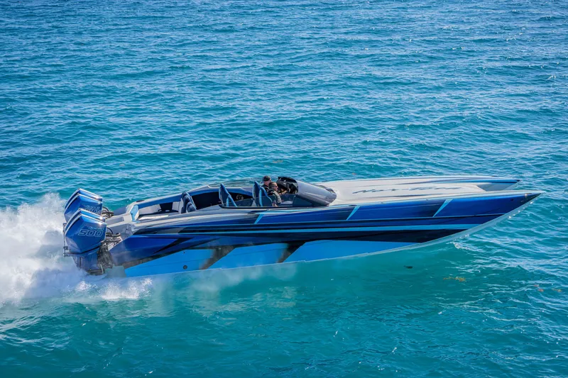Slide: The Image of 2026 Nor-Tech 4000 Super Catamaran speeding on clear blue ocean waters. - 156