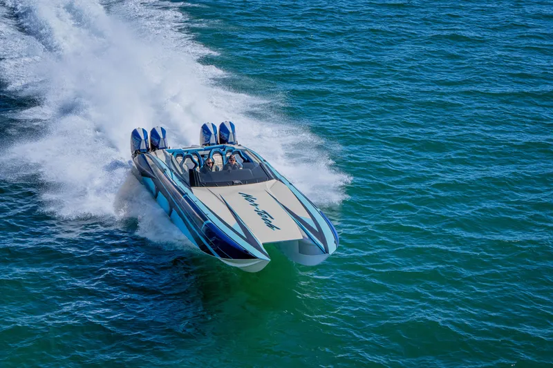 Slide: The Image of 2026 Nor-Tech 4000 Super Catamaran speeding on open water, showcasing sleek design. - 164