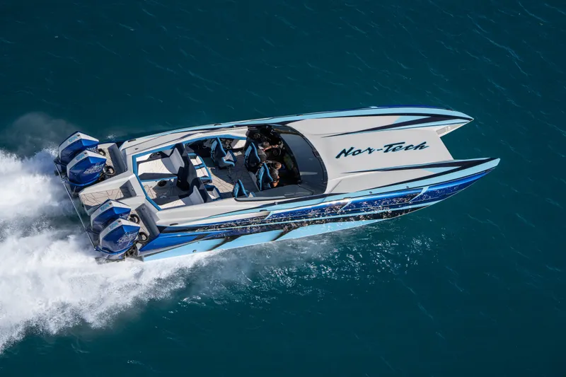 Slide: The Image of 2026 Nor-Tech 4000 Super Catamaran speeding on blue ocean waters. - 173