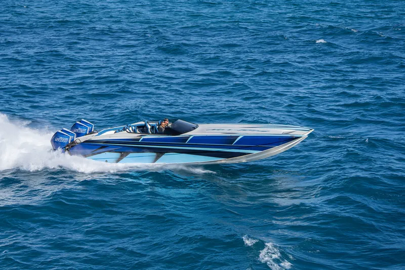 Slide: The Image of 2026 Nor-Tech 4000 Super Catamaran speeding on open blue ocean waters. - 174
