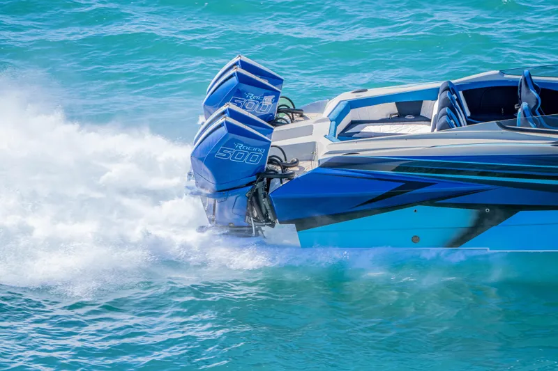 Slide: The Image of 2026 Nor-Tech 4000 Super Catamaran with twin Racing 500 engines on blue water. - 180