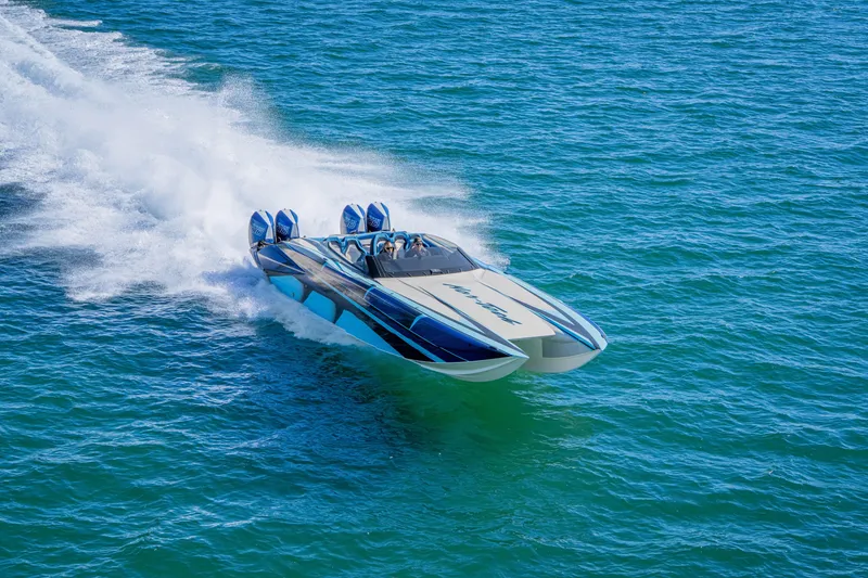 Slide: The Image of 2026 Nor-Tech 4000 Super Catamaran speeding on open water, showcasing sleek design and power. - 181