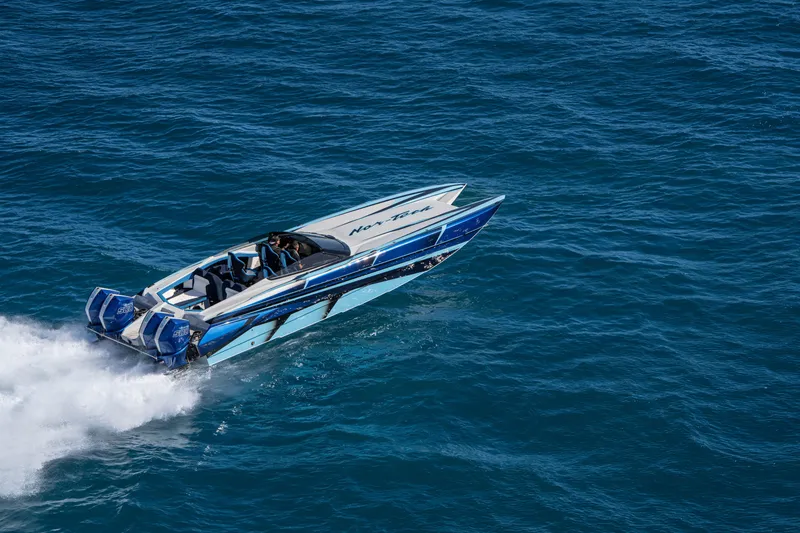 Slide: The Image of 2026 Nor-Tech 4000 Super Catamaran speeding on open water, showcasing sleek design and power. - 183