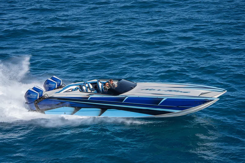 Slide: The Image of 2026 Nor-Tech 4000 Super Catamaran speeding on open water, showcasing sleek design and powerful engines. - 185
