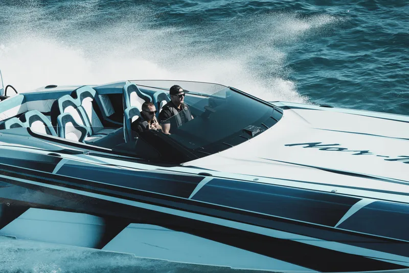 Slide: The Image of 2026 Nor-Tech 4000 Super Catamaran cruising on open water, showcasing sleek design and speed. - 189