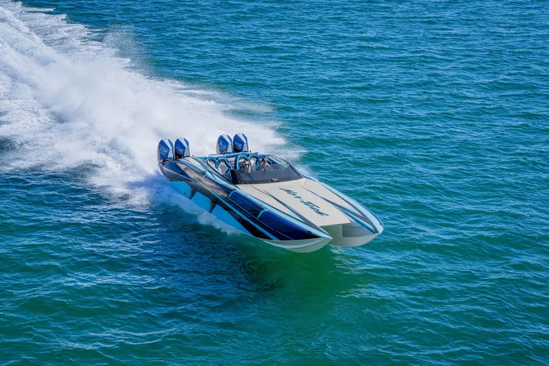 Slide: The Image of 2026 Nor-Tech 4000 Super Catamaran speeding on open water, showcasing sleek design and power. - 20