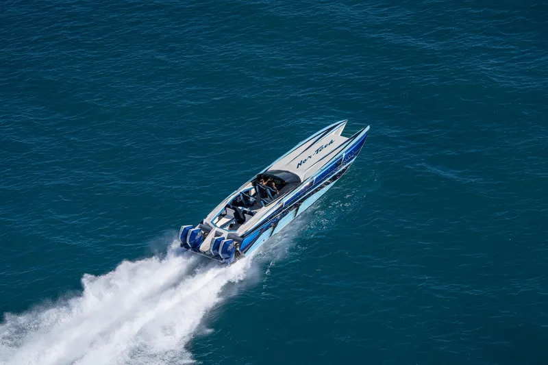 Slide: The Image of 2026 Nor-Tech 4000 Super Catamaran speeding on open water, showcasing sleek design. - 205