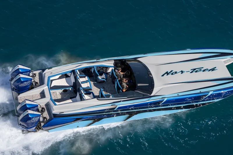 Slide: The Image of 2026 Nor-Tech 4000 Super Catamaran cruising on blue water, aerial view. - 21