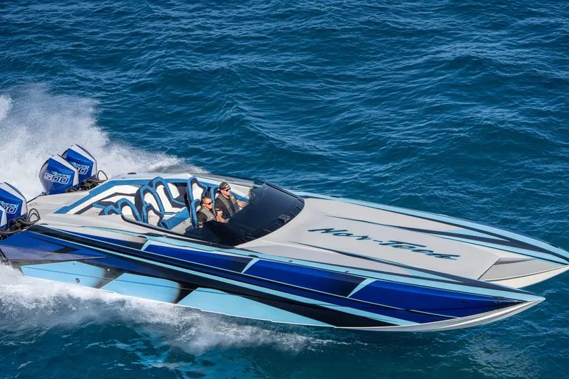 Slide: The Image of 2026 Nor-Tech 4000 Super Catamaran speeding on ocean with vibrant blue design. - 22