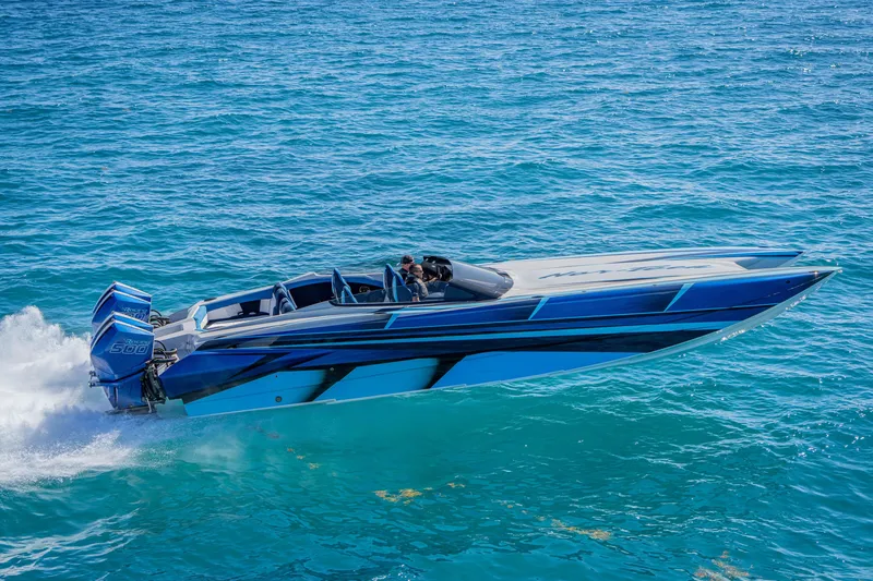 Slide: The Image of 2026 Nor-Tech 4000 Super Catamaran speeding on clear blue ocean waters. - 220