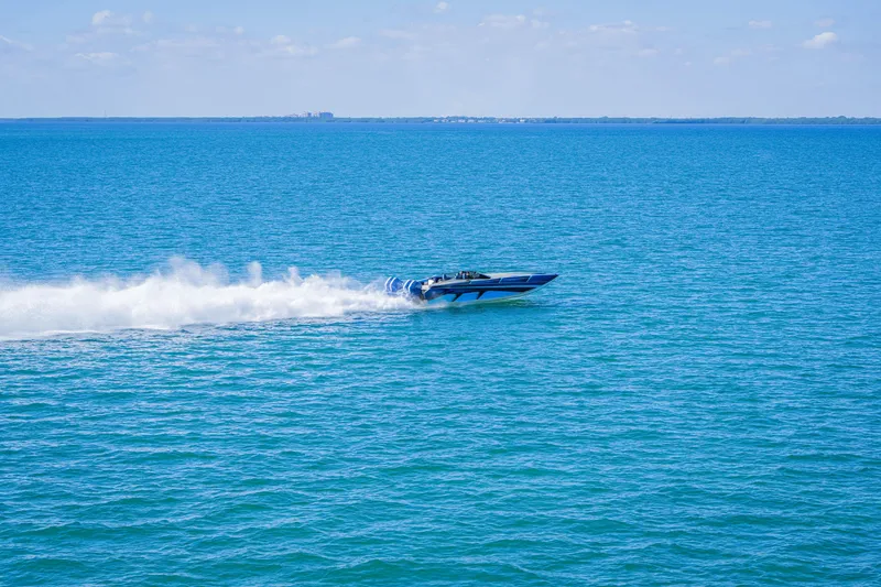 Slide: The Image of 2026 Nor-Tech 4000 Super Catamaran speeding across blue ocean waters. - 32