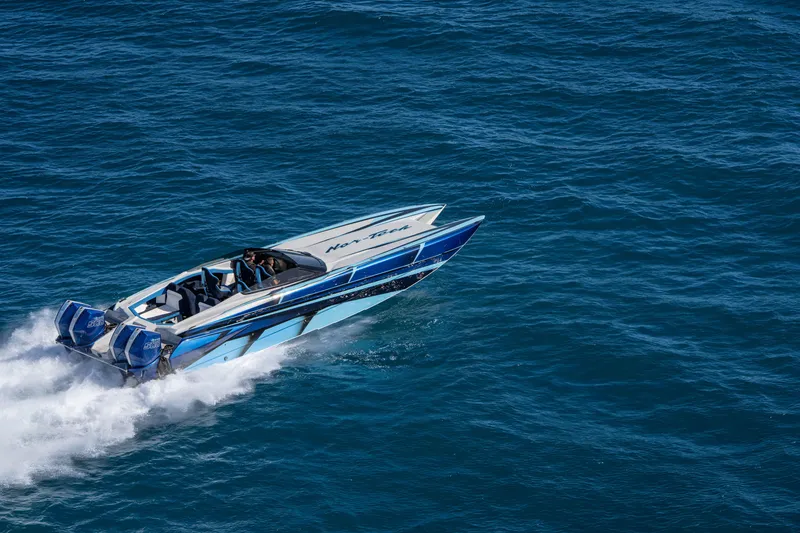 Slide: The Image of 2026 Nor-Tech 4000 Super Catamaran cruising on open water. - 38