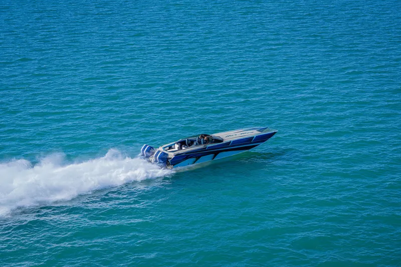Slide: The Image of 2026 Nor-Tech 4000 Super Catamaran speeding on open blue water. - 48