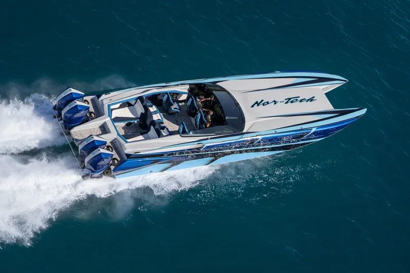 Slide: The Image of 2026 Nor-Tech 4000 Super Catamaran speeding on blue ocean waters. - 52